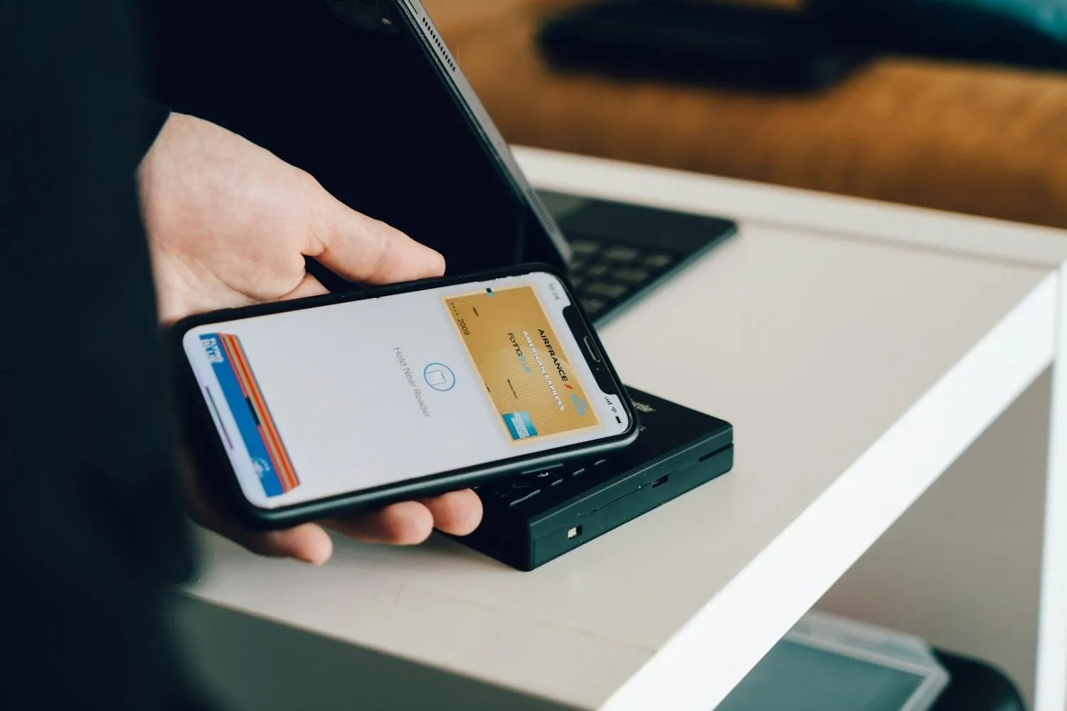 A phone held over a card reader